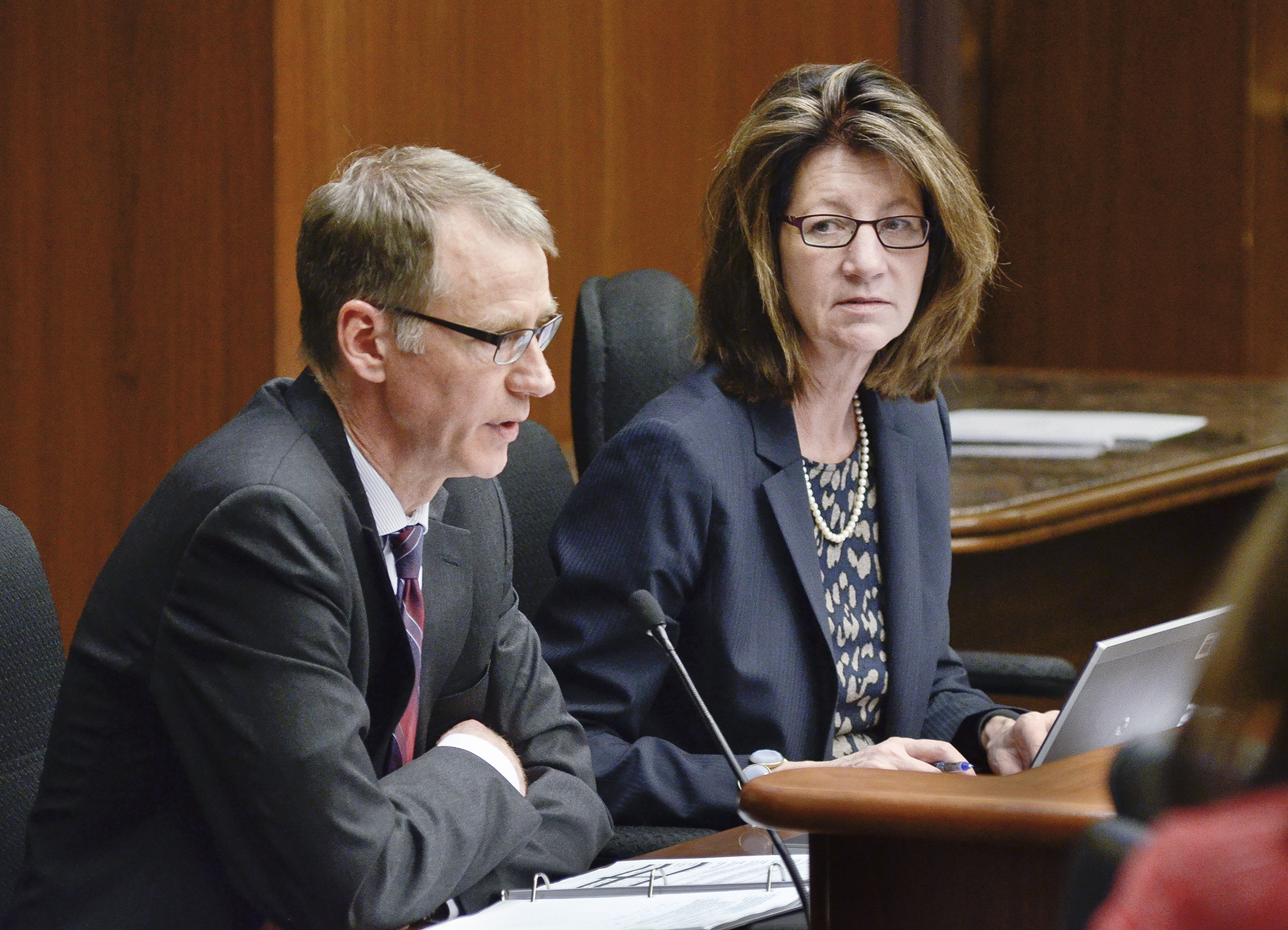 Deputy Human Services Commissioner Chuck Johnson, left, and Commissioner Lucinda Jesson present an overview of the governor’s biennial budget proposal for the Department of Human Services to members of the House Health and Human Services Finance Committee Jan. 29. Photo by Andrew VonBank